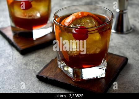 Old fashioned cocktail with orange peel garnish and maraschino cherry Stock Photo