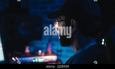 close-up of a boy focused on the computer with soft light Stock Photo