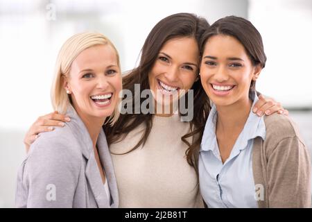 Well get the job done. Cropped portrait of three businesswomen standing in the office. Stock Photo