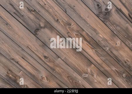 Old wooden worn fence boards weathered texture brown dirty obsolete plank background. Stock Photo