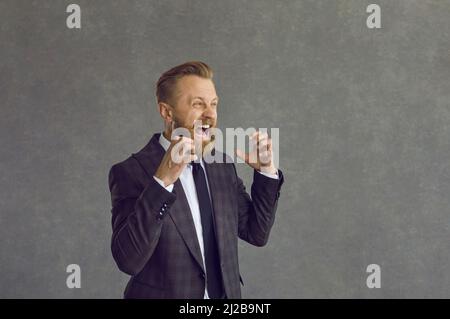 Angry furious businessman screaming loudly cant control negative emotions Stock Photo