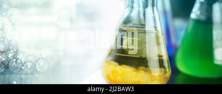 yellow and green flask glass and test tube in medical microbiology lab white banner background Stock Photo