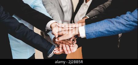 Multicultural business people stacking hands with colleagues inside modern office - Focus on African man hands Stock Photo