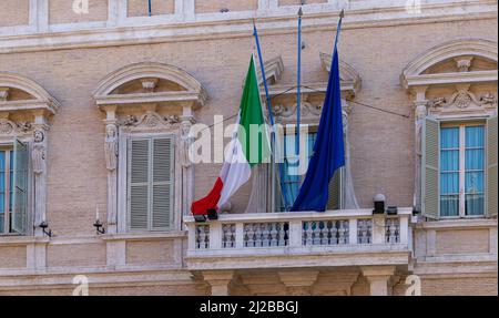 A picture of the Italian and European Union flags on a building facade. Stock Photo