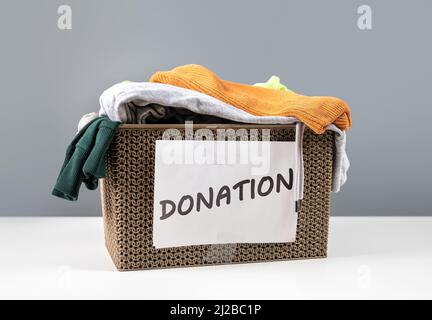 clothing for donation. Donation box with used clothes at home to support help for poor people. Package with used clothes for donate, second hand use f Stock Photo