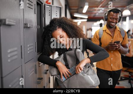 Young diverse students on campus getting ready for the day Stock Photo