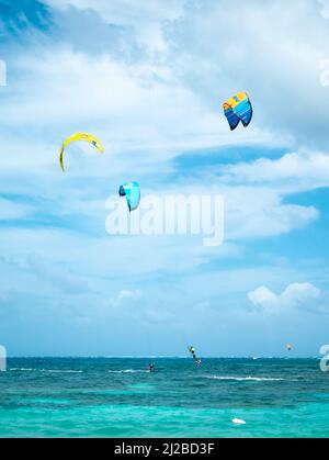 San Andres, Colombia - November 17 2021: Men Kitesurfing in the Sea on a Cloudy Day Stock Photo