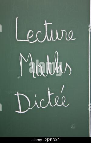 Reading, maths and dictation on the board of a classroom in a primary school Stock Photo