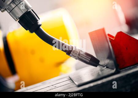 Industrial arm robot CNC automatic welding metal production in factory. Stock Photo