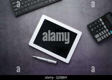 top view of digital tablet with office suppliers on black background  Stock Photo