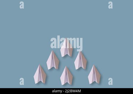six paper airplanes isolated on a blue background Stock Photo - Alamy