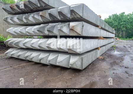 piles for the foundation are stockpiled in anticipation of pile driving for the foundation in accordance with the construction project, selective focu Stock Photo