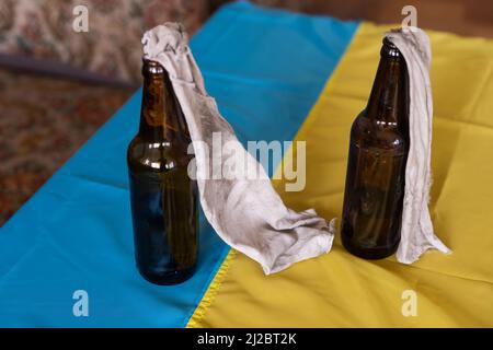 Molotov cocktail bottle on flag of ukraine background Stock Photo