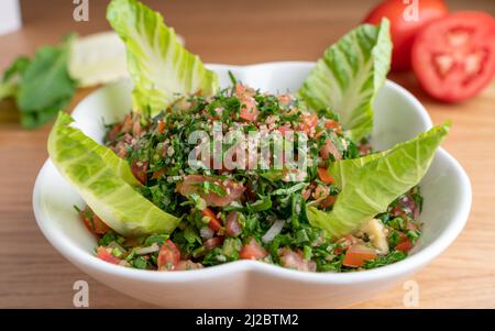 A bowl of delicious fresh Tabbouleh (tabbouli) salad. Stock Photo