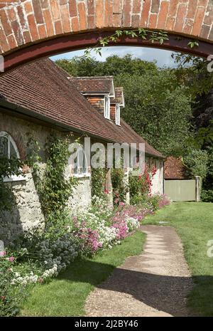 Rose Covered Cottages taken through arch Stock Photo