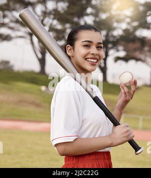 Ready to lose. Shot of an attractive young woman standing alone outside and posing with a baseball bat. Stock Photo