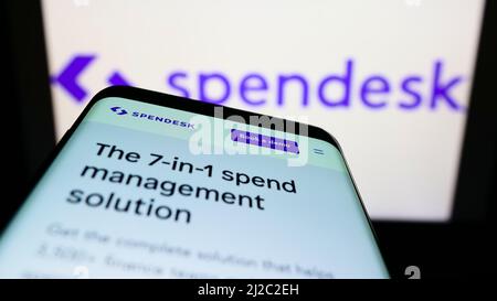 Smartphone with webpage of French fintech company Spendesk SAS on screen in front of business logo. Focus on top-left of phone display. Stock Photo