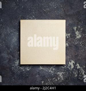 Photo of closed blank kraft brochure on concrete background. Template for placing your design. Top view with copy space. Flat lay. Stock Photo