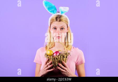 Easter. Girl in bunny ears with basket colorful eggs. Rabbit woman. Spring holidays. Sale. Discount. Stock Photo