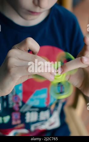Boy using fidget spinner Stock Photo