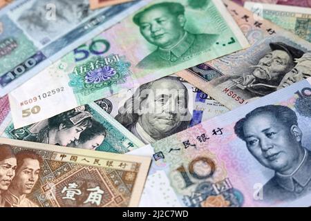 US dollar surrounded by Chinese yuan banknotes. Concept of trade war between the China and USA Stock Photo
