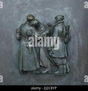 Slovak partisans during World War II depicted in the bronze relief by Slovak sculptor Rudolf Pribiš placed on the main door to the Slavín Memorial in Bratislava, Slovakia. The war memorial devoted to Red Army soldiers fallen during World War II was designed by Slovak architect Ján Svetlík and build between 1957 and 1960. Stock Photo