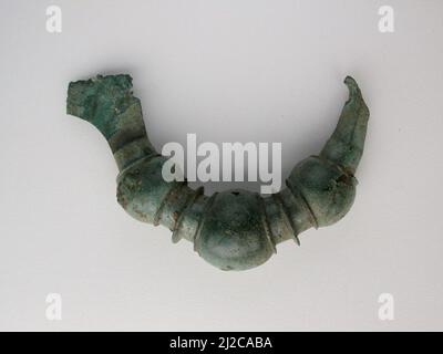 This precious bronze object is a votive, or devotional gift, made as an offering to the gods. They come in many forms, such as animals, beads and brooches. Many seem once to have been attached to something else. Votiveswere hung from sacred trees or placed in sanctuaries around Greece. Once a shrine was full, the votives were ceremonially buried to make room for more offerings. Stock Photo