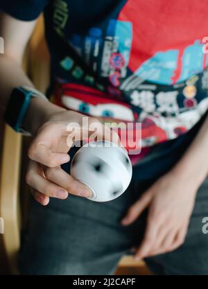 Boy using fidget spinner Stock Photo
