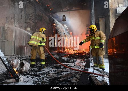 Kuwait City, Kuwait. 31st Mar, 2022. Firefighters battle a fire at Al-Mubarakiya market in Kuwait City, Kuwait, on March 31, 2022. A total of 14 injured on Thursday afternoon as a huge fire broke out at Kuwait's popular Al-Mubarakiya market in Kuwait City, the Kuwait News Agency (KUNA) said. Credit: Asad/Xinhua/Alamy Live News Stock Photo
