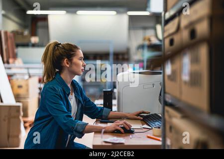 Young woman working in an industrial place of work Stock Photo