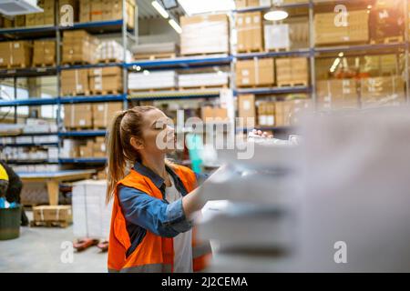 Young woman working in an industrial place of work Stock Photo