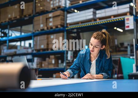Young woman working in an industrial place of work Stock Photo