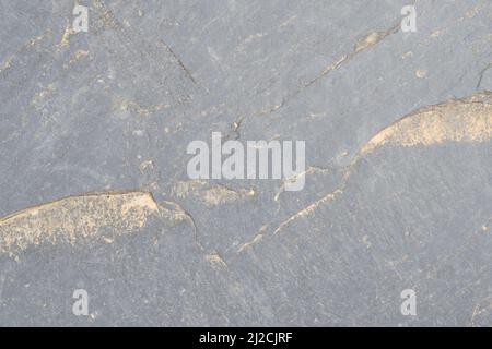 Rough grey stone wall, natural old weathered rock texture with sand. Nature background Stock Photo