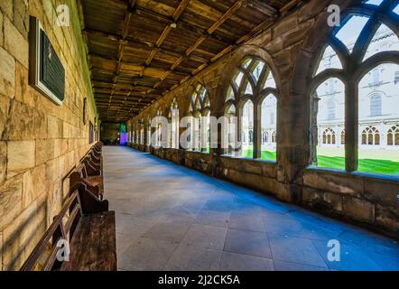 These covered archways-cloisters are at Durham Cathedral. Opened in 1133 the cathedral is the greatest Norman style building in England Stock Photo
