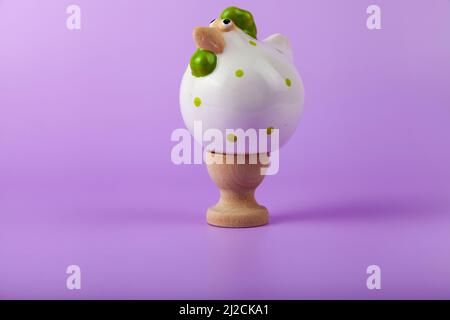Easter card design. Easter chick on a stand  on lilac background. Stock Photo