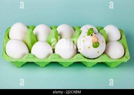 Happy Easter. Easter eggs. Chicken white eggs on green background. Easter chicken. Closeup. Stock Photo