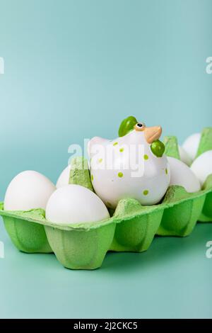 Happy Easter. Easter eggs. Chicken white eggs on green background. Easter chicken. Closeup. Stock Photo