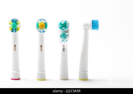 four replacement electric toothbrush heads stood up one facing to the side isolated from white background no people nobody Stock Photo
