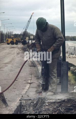 Reinforcing roadbed of Sheridan Road bordering Lake Michigan in the Evanston area  ca.  1973 Stock Photo