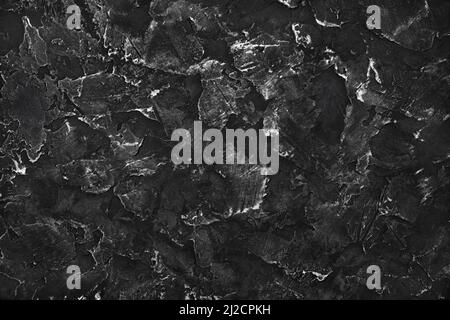 Black plaster background. Black stucco texture. Top view. Flat lay. Stock Photo
