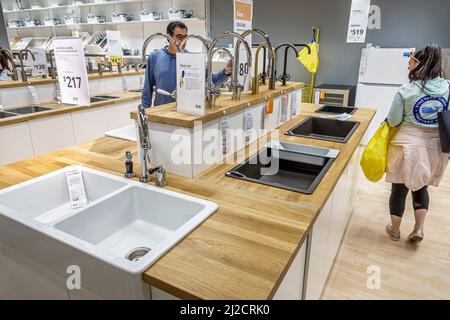 Miami Florida IKEA home goods furnishings accessories furniture decor shopping shoppers inside interior display sale sinks man woman couple looking Stock Photo