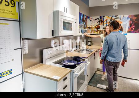 Miami Florida IKEA home goods furnishings accessories furniture decor shopping shoppers inside interior display sale kitchen cabinets man woman couple Stock Photo