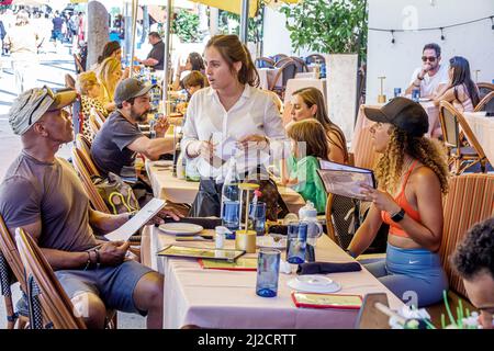 Miami Beach Florida Lincoln Road Pedestrian Mall restaurant al fresco dining Black couple man woman waitress server taking order Stock Photo