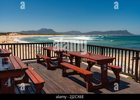 South Africa. 2022. Seafront cafe restaurant seating overlooking the beach, sea and mountains. Stock Photo