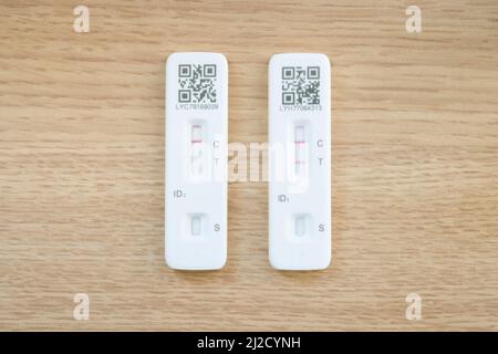 UNITED KINGDOM - March 26, 2022. Covid 19 testing. Two LFT (Lateral Flow Test) tests, showing positive and negative results. Flat lay of Covid-19 test Stock Photo
