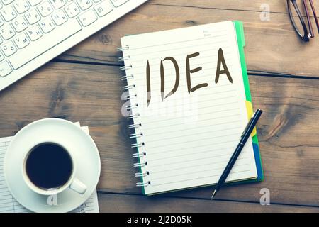 idea write on notepad andkeyboard and coffee on table Stock Photo