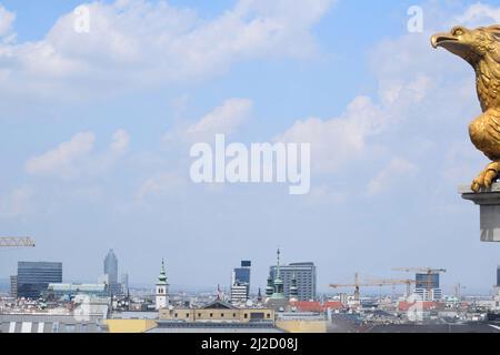 Vienna city view with buildings and sky from Saint Charles Church roof top. Detail of a golden eagle. Vienna, Austria Stock Photo