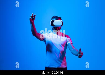 Architect in VR glasses working in augmented reality. Man wearing virtual reality glasses, sliding and zooming while interacting with a interface of Stock Photo