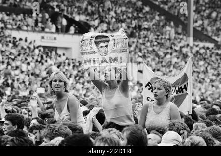 Fans enjoy Wham ! The Farewell Concert at Wembley Stadium, London on 28th June 1986. Wham !,  (singer George Michael, and singer/guitarist Andrew Ridgeley) played their final concert as Wham !, although Andrew joined George as a guest on a few later George Michael solo shows.  Picture taken 28th June 1986 Stock Photo