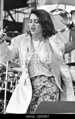 Live Aid dual venue benefit concert held on 13th July 1985 at Wembley Stadium in London, England, and the John F. Kennedy Stadium in Philadelphia, Pennsylvania, United States. The concerts were organised as a follow up to the Band Aid single 'Do They Know Its Christmas?'  to raise money for victims of the famine in Ethiopia. Picture shows  Madonna performing on stage during the concert in Philadelphia. Stock Photo